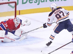 Edmonton Oilers' Connor McDavid scores the game-winning goal on Jake Allen during overtime in Montreal on May 10, 2021.