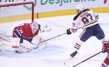 Edmonton Oilers' Connor McDavid scores the game-winning goal on Jake Allen during overtime in Montreal on Monday, May 10, 2021.