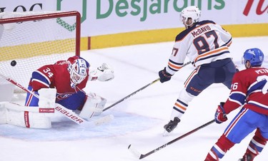 Edmonton Oilers' Connor McDavid scores the game-winning goal on Jake Allen as Jeff Petry trails the play during overtime in Montreal on Monday, May 10, 2021.