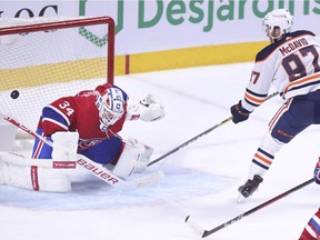 Edmonton Oilers Connor McDavid scores the game-winning goal on Montreal Canadiens goalie Jake Allen as Jeff Petry trails the play during overtime of National Hockey League game in Montreal Monday May 10, 2021.