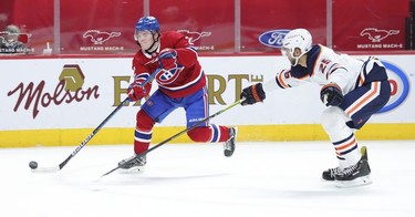 Cole Caufield gets around Edmonton Oilers' Darnell Nurse and gets a shot off during third-period action in Montreal on Monday, May 10, 2021.