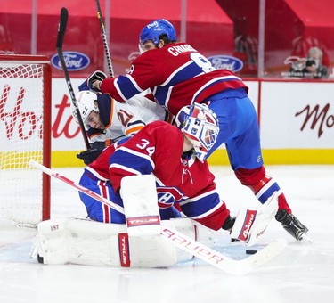 Jake Allen makes a save as defenceman Ben Chiarot shoves Edmonton Oilers' Dominik Kahun into the net during second-period action in Montreal on Monday, May 10, 2021.