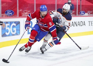 Ben Chiarot holds off Edmonton Oilers'Jujhar Khaira during second-period action in Montreal on Monday, May 10, 2021.