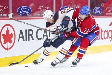 Jake Evans forechecks against Edmonton Oilers Tyson Barrie during first- period action in Montreal on Monday, May 10, 2021.