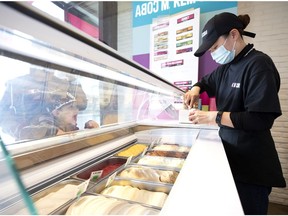 A young boy looks on with excitement as Ailin prepares his order at the new Kem CoBa location in the Mercier East district f Montreal, on Wednesday, May 12, 2021.