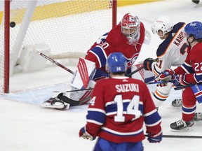 Edmonton Oilers Dominik Kahun shoots the puck past Montreal Canadiens goalie Cayden Primeau for the game-winning goal as Cole Caulfield and Nick Suzuki watch during overtime of National Hockey League game in Montreal Wednesday May 12, 2021.