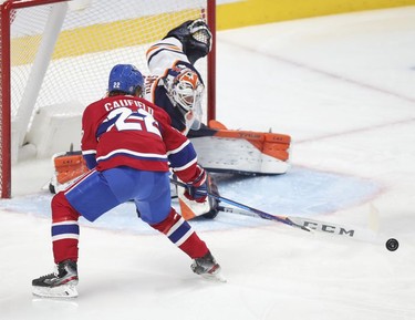 Cole Caufield has the puck poked away from him by Edmonton Oilers goalie Mike Smith during third-period action in Montreal on Wednesday, May 12, 2021.