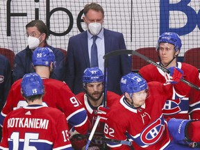 Montreal Canadiens goaltender coach Sean Burke watches a line change behind the team's bench during first period of National Hockey League game in Montreal Wednesday May 12, 2021.  Burke was working the bench because assistant coach Alex Burrows had COVID symptoms and was kept away from the team. (John Mahoney / MONTREAL GAZETTE) ORG XMIT: 66129 - 4693