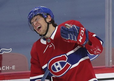 Jake Evans grimaces after taking a hard fall during second-period action  in Montreal on Wednesday, May 12, 2021.
