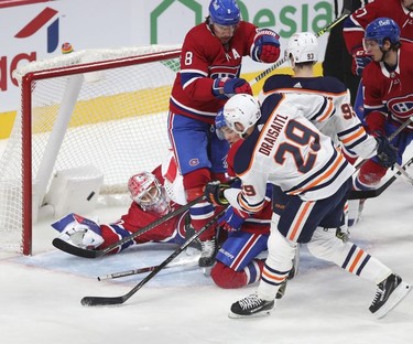 Edmonton Oilers' Leon Draisaitl shoots the puck past sprawling goalie Cayden Primeau after picking up loose puck in a net-front scramble during second-period action  in Montreal on Wednesday, May 12, 2021.