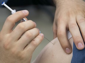 Administering the Pfizer-BioNTech COVID-19 vaccine on Thursday May 13, 2021, at the Palais des Congrès.