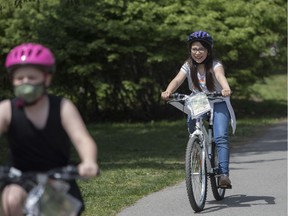 Hannah Paz Agudelo Arias (right) and Léa Favreau try out their new bicycles at Jarry Park at Sun Youth's 37th annual bike distribution, a.k.a. the annual Avi Morrow Bike Giveaway in Montreal on Saturday, May 15, 2021. Avrum "Avi" Morrow died in 2019, after years of being the anonymous donor behind the annual giveaway of bikes, helmets and locks to deserving children through Sun Youth.