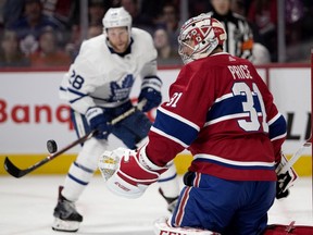 Toronto Maple Leafs' Connor Brown's shot bounces off Montreal Canadiens goaltender Carey Price in Montreal on Feb. 9, 2019.