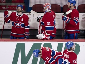Canadiens' Brendan Gallagher and Cole Caufield show their frustration on the ice, as Paul Byron, from left, Carey Price and Joel Edmundson react on the bench after Monday night's 2-1 loss to the Maple Leafs at the Bell Centre.