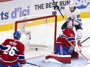 Toronto Maple Leafs centre William Nylander celebrates scores on Canadiens goaltender Carey Price as defenceman Jeff Petry looks on in Montreal on May 25, 2021.
