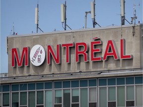 The Montreal sign atop the Pierre Elliott Trudeau Airport bears the drawing of a COVID-19 vaccination, on Friday, May 28, 2021.
