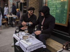 David King (left) and Abraham Linkin have a night out at Stem Bar in Montreal on May 28, 2021. Friday was the first night in Quebec with no curfew since Jan. 9.