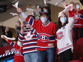 Fans cheers on their team during warmup as the Montreal Canadiens host the Toronto Maple Leafs for game six of their first-round NHL playoff series at the Bell Centre on Saturday May 29, 2021.