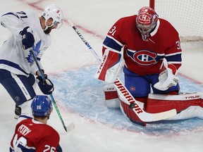Carey Price stops a shot by Toronto Maple Leafs' Nick Foligno  during first-period action in Game 6 of the first-round NHL playoff series in Montreal on Saturday, May 29, 2021.