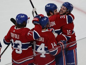 Montreal Canadiens' Jesperi Kotkaniemi (15) celebrates his game winning goal with teammates Tyler Toffoli, Nick Suzuki and Erik Gustafsson during overtime in Game 6 in Montreal on May 29, 2021.