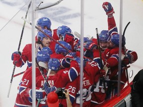 MONTREAL, QUE.: MAY  29, 2021 --

Montreal Canadiens players mob Jesperi Kotkaniemi following his game game winning goal during overtime period action, in game six of the first-round NHL playoff series in Montreal on Saturday May 29, 2021. (Pierre Obendrauf / MONTREAL GAZETTE) ORG XMIT: 66217 - 4612