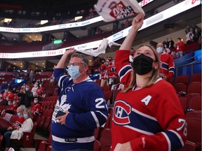 Fans Mike Sutherland and daughter Sarah cheer on their teams as the Montreal Canadiens and Toronto Maple Leafs warm up prior to Game 6 of their first round NHL playoff series at the Bell Centre on Saturday, May 29, 2021.