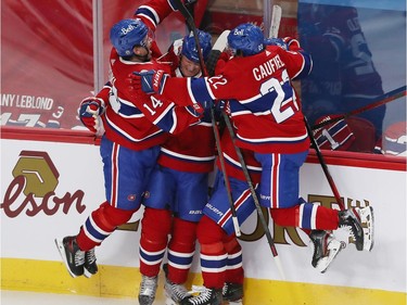 Canadiens' Corey Perry, centre, celebrates his goal with teammates during third period action in Game 6 of the first-round NHL playoff series in Montreal on Saturday, May 29, 2021.