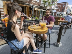 Pub West Shefford customers enjoy drinks on the terrace of the resto-bar in Montreal's Plateau Mont-Royal district on June 25, 2020.
