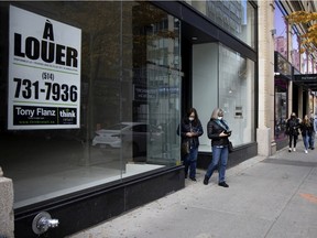 MONTREAL, QUE.: October 25, 2020 -- Pedestrians walk past an empty and for rent storefront on Sainte-Catherine Street in Montreal, on Sunday, October 25, 2020. (Allen McInnis / MONTREAL GAZETTE) ORG XMIT: 652