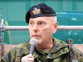 A Canadian Forces member, introduced by organizers of an anti-lockdown rally as Leslie Kenderesi speaks at the gathering in Toronto.