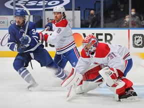 Habs defenceman Ben Chiarot battles Leafs' Auston Matthews in front of goaltender Carey Price Thursday night in Toronto. Price made 35 saves to lead Montreal to a 2-1 win in Game 1 of the series.