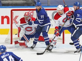 Canadiens' Carey Price stands his ground with Nick Foligno of the Toronto Maple Leafs looking to tip a shot in Game 1 of their semifinal series at Scotiabank Arena on Thursday, May 20, 2021, in Toronto.