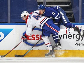 Canadiens' Joel Edmundson takes Zach Hyman of the Toronto Maple Leafs into the boards in Game 2 of the first round of the 2021 Stanley Cup Playoffs at Scotiabank Arena on Saturday, May 22, 2021, in Toronto.