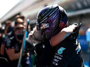 Pole position qualifier Lewis Hamilton of Great Britain and Mercedes GP celebrates with a team member during qualifying for the F1 Grand Prix of Spain at Circuit de Barcelona-Catalunya on May 08, 2021 in Barcelona, Spain.