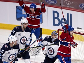 Montreal Canadiens right wing Joel Armia (40) celebrates scoring against Winnipeg Jets goaltender Connor Hellebuyck (37) during NHL action in Montreal on Friday, April 30, 2021. Montreal Canadiens right wing Tyler Toffoli (73) is also seen.
