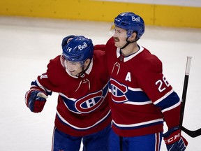 Montreal Canadiens center Nick Suzuki (14), left and Montreal Canadiens defenseman Jeff Petry (26) celebrate scoring the winning goal against Winnipeg Jets goaltender Connor Hellebuyck (37) during NHL action in Montreal on Friday, April 30, 2021.