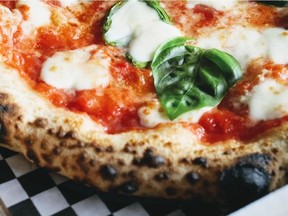 Patrick Liu's Curfew Pizza is serving up some highly studied pies: 00 flour from Italy, local fresh mozzarella, organic tomatoes from California, and fresh basil on a crust with light and airy cornicione sporting a leopard-like charring pattern.