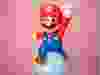 A Super Mario figurine in a classic jumping pose.