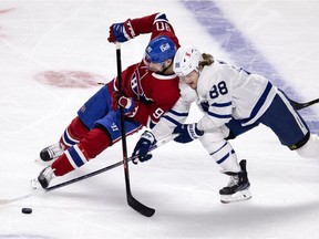Montreal Canadiens left wing Tomas Tatar (90) leans on and takes the puck from Toronto Maple Leafs center William Nylander (88) during NHL playoff action in Montreal on Monday, May 24, 2021. (Allen McInnis / MONTREAL GAZETTE)