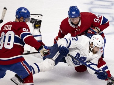 Montreal Canadiens right wing Corey Perry (94) sends Toronto Maple Leafs center Alex Galchenyuk (12) to the ice as Habs left wing Tomas Tatar (90) looks on during NHL playoff action in Montreal on Monday, May 24, 2021. (Allen McInnis / MONTREAL GAZETTE) ORG XMIT: 66189