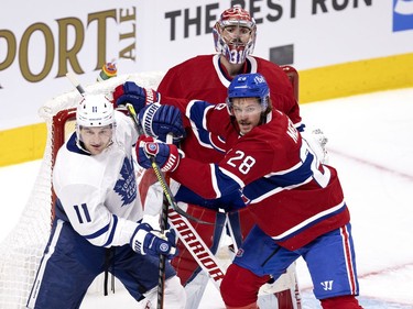 Montreal Canadiens goaltender Carey Price (31) tries to see over top of  defenseman Jon Merrill (28), as Merrill clears Toronto Maple Leafs left wing Zach Hyman (11) from the front of the net during NHL playoff action in Montreal on Monday, May 24, 2021. (Allen McInnis / MONTREAL GAZETTE) ORG XMIT: 66189