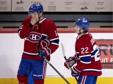 Montreal Canadiens center Nick Suzuki (14) and Montreal Canadiens right wing Cole Caufield (22)reacts as they watch the Toronto Maple Leafs celebrate winning round one game 3 by a 2-1 score during NHL playoff action in Montreal on Monday, May 24, 2021.