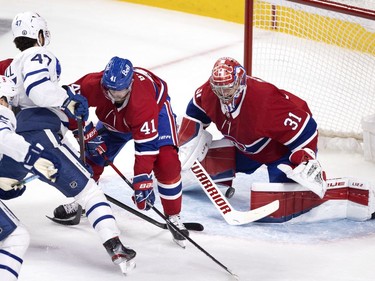 Montreal Canadiens goaltender Carey Price (31) gets his stick on the puck as Montreal Canadiens right wing Paul Byron (41) keeps Toronto Maple Leafs left wing Pierre Engvall (47) at bay during NHL playoff action in Montreal on Tuesday, May 25, 2021.