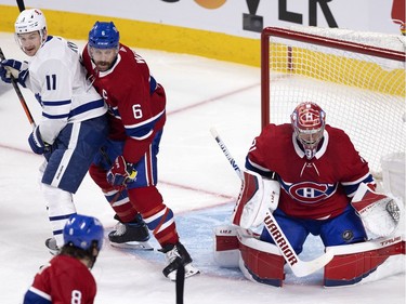 Montreal Canadiens defenseman Shea Weber (6) ties up Toronto Maple Leafs left wing Zach Hyman (11) as Montreal Canadiens goaltender Carey Price (31) prepares to glove the puck during NHL playoff action in Montreal on Tuesday, May 25, 2021.