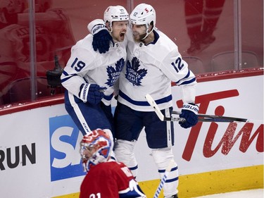 Toronto Maple Leafs center Jason Spezza (19) and Alex Galchenyuk (12) celebrate scoring the Leaf's second goal against Montreal Canadiens goaltender Carey Price (31) during NHL playoff action in Montreal on Tuesday, May 25, 2021.