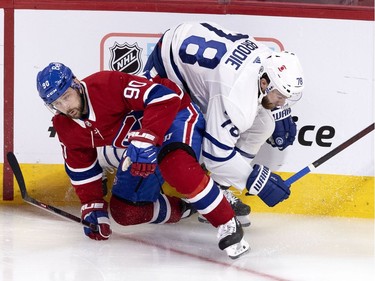 Montreal Canadiens left wing Tomas Tatar (90) grimaces as he collides with Toronto Maple Leafs defenseman T.J. Brodie (78) during NHL playoff action in Montreal on Tuesday, May 25, 2021.