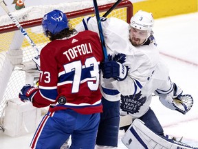 Montreal Canadiens right wing Tyler Toffoli (73) takes a puck in the back as Toronto Maple Leafs defenceman Justin Holl (3) tries to clear him from the crease during NHL playoff action in Montreal on Tuesday, May 25, 2021.