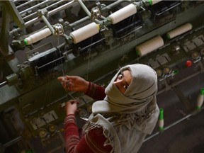 An artisan works at a silk factory in Kashmir. According to legend, the production of silk dates back to around 2700 B.C.