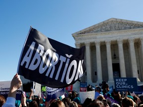 A demonstrator holds up an abortion flag outside of the U.S. Supreme Court as justices hear a major abortion case on the legality of a Republican-backed Louisiana law that imposes restrictions on abortion doctors, on Capitol Hill in Washington, D.C., March 4, 2020.
