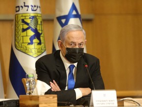 Israeli Prime Minister Benjamin Netanyahu, wearing a mask for protection against the COVID-19 pandemic, attends a special cabinet meeting on the occasion of "Jerusalem Day" at the city's municipality building on May 9, 2021.